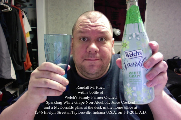 Randall M. Rueff with a bottle of Welch's Family Farmer Owned Sparkling White Grape Non-Alcoholic Juice Cocktail and a McDonalds glass at the desk in the home office at 1246 Evelyn Street in Taylorsville, Indiana U.S.A. on 1-1-2015 A.D.